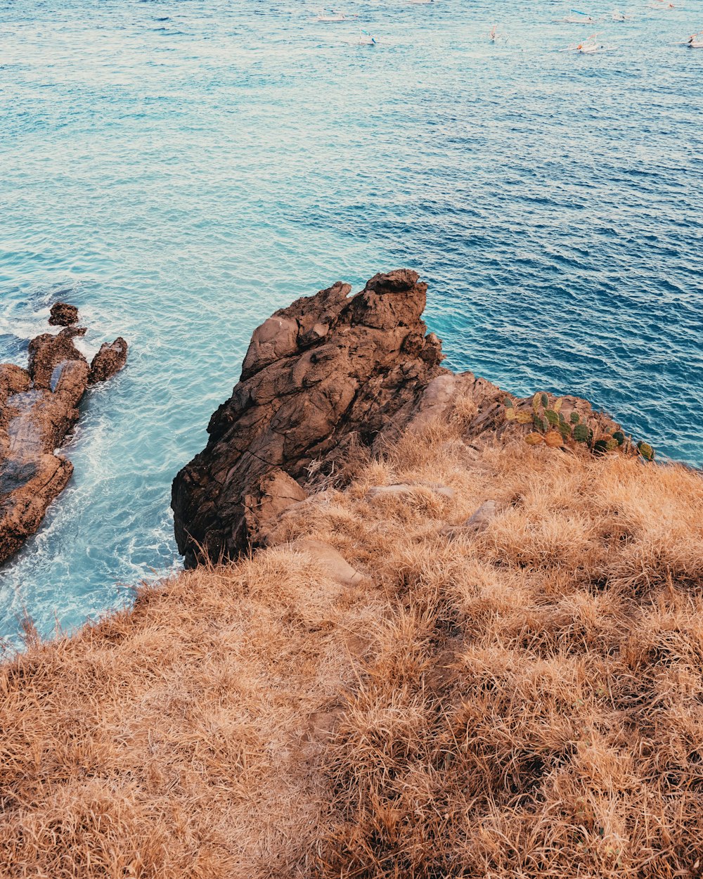 brown rock formation near body of water during daytime