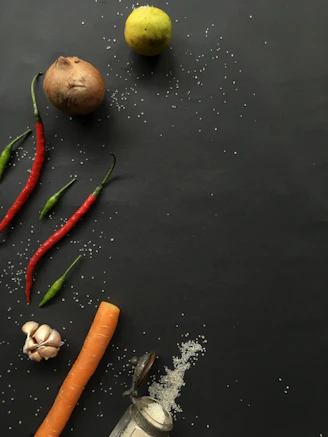 green red and orange chili on black table