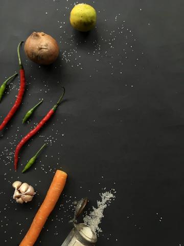 green red and orange chili on black table