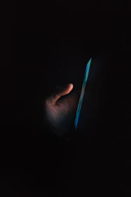 A gentle hand holding a phone with a text message from Nora, glowing softly.