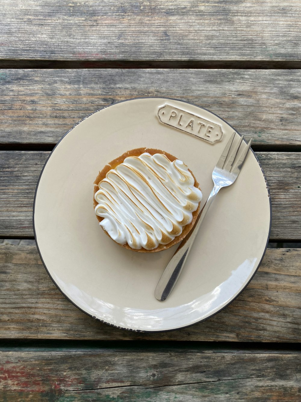 white ceramic round plate with silver fork