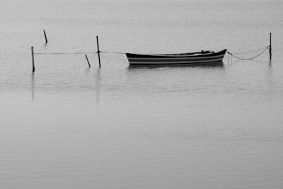 grayscale photo of boat on body of water