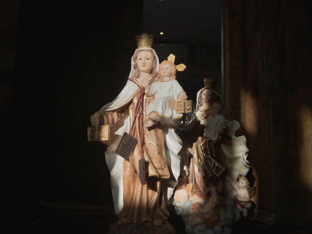 man in white robe holding a baby in white dress