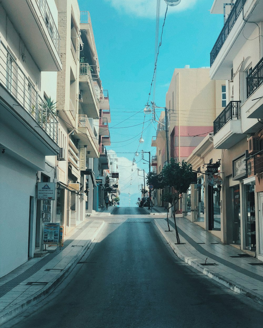 people walking on sidewalk between buildings during daytime