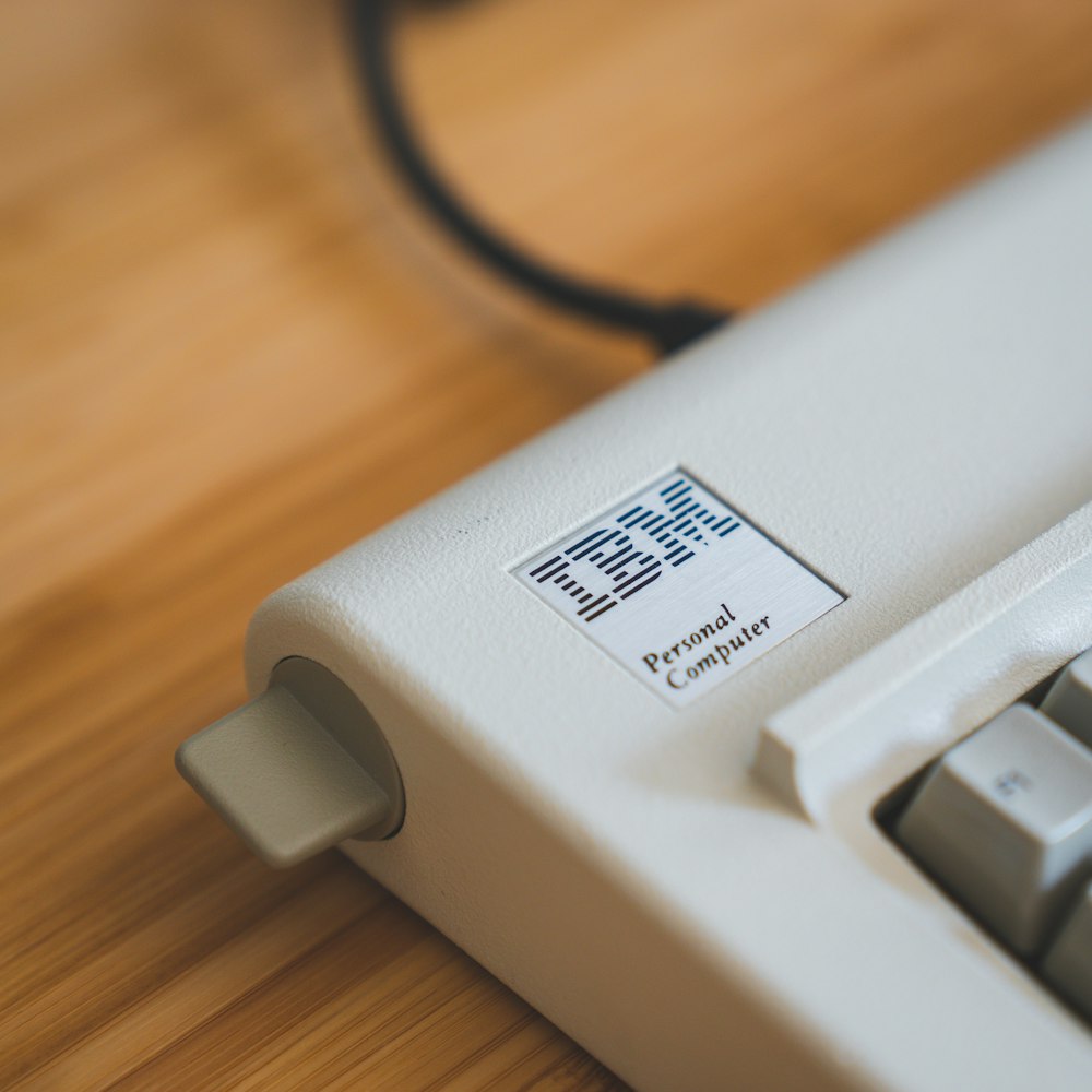 white electronic device on brown wooden table