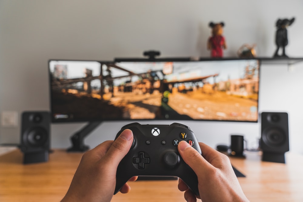 person holding black game controller