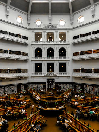 people walking inside building with glass walls