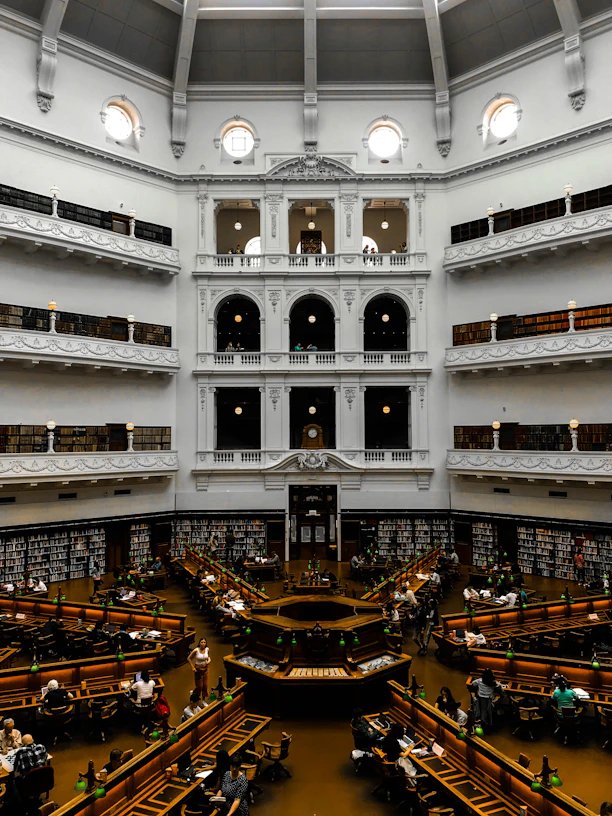 people walking inside building with glass walls