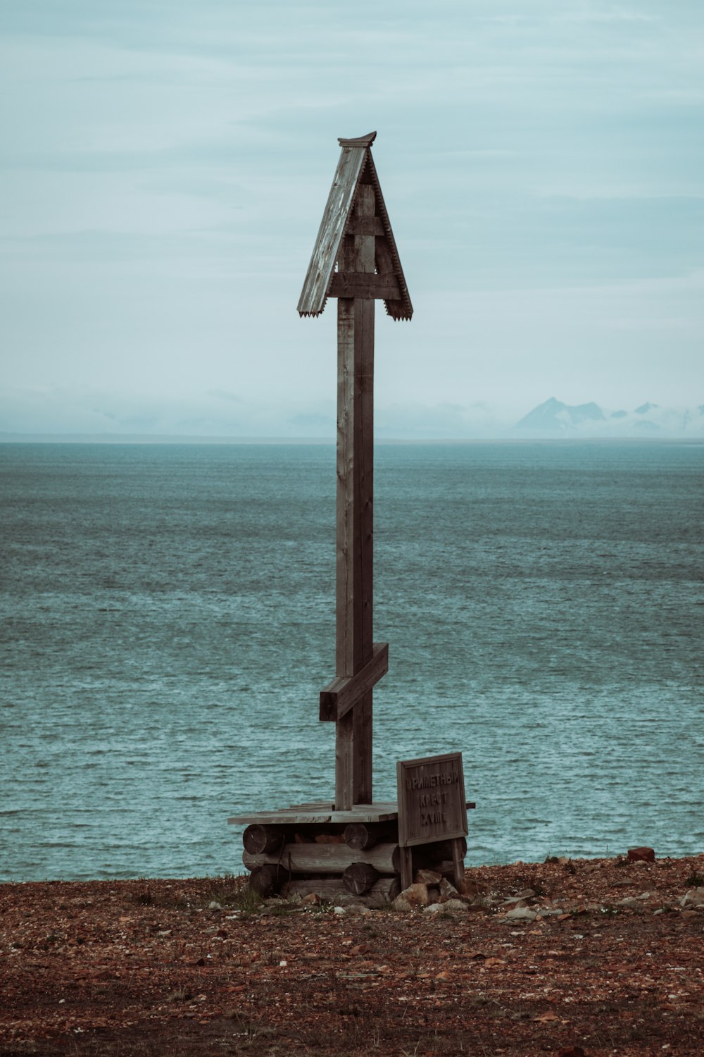 brown wooden post near body of water during daytime