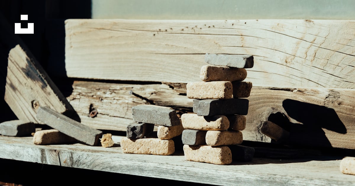 Brown wooden log stack on white wooden table photo – Free Grey Image on ...