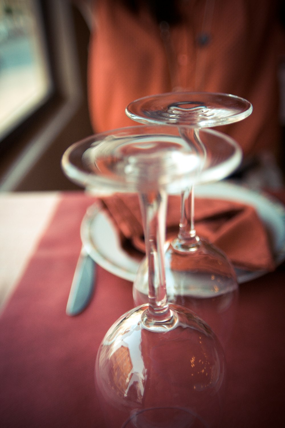 clear wine glass on white ceramic saucer