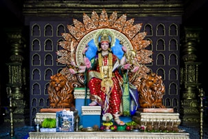 hindu deity statue on gold and gold armchair