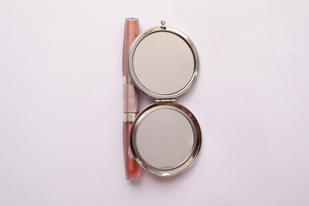 silver and red makeup mirror