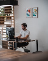 African man providing customer support via headset in a modern office.