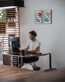 A confident modern man working at a desk with productivity tools and a calm, focused expression.