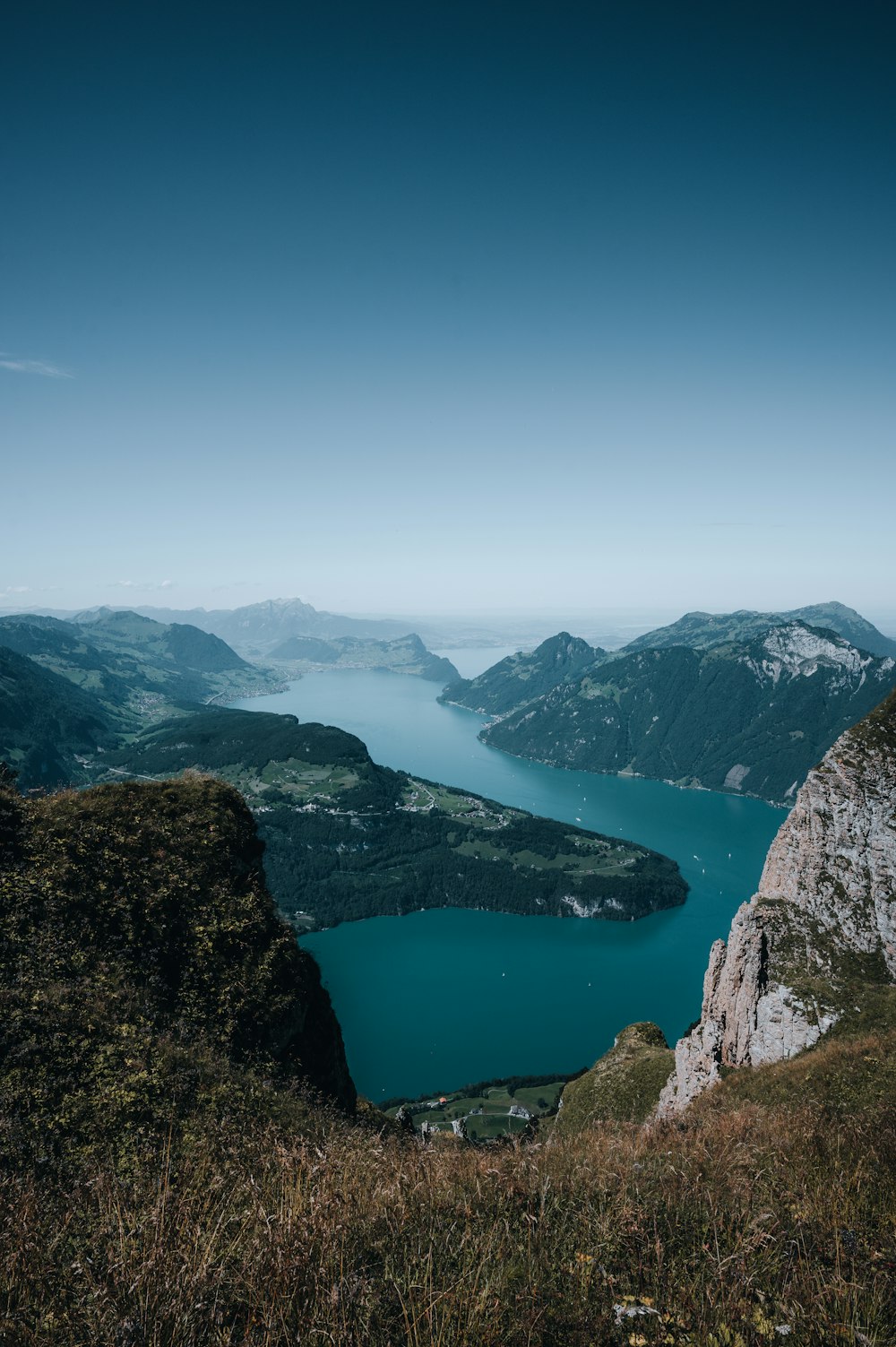 aerial view of lake between mountains during daytime