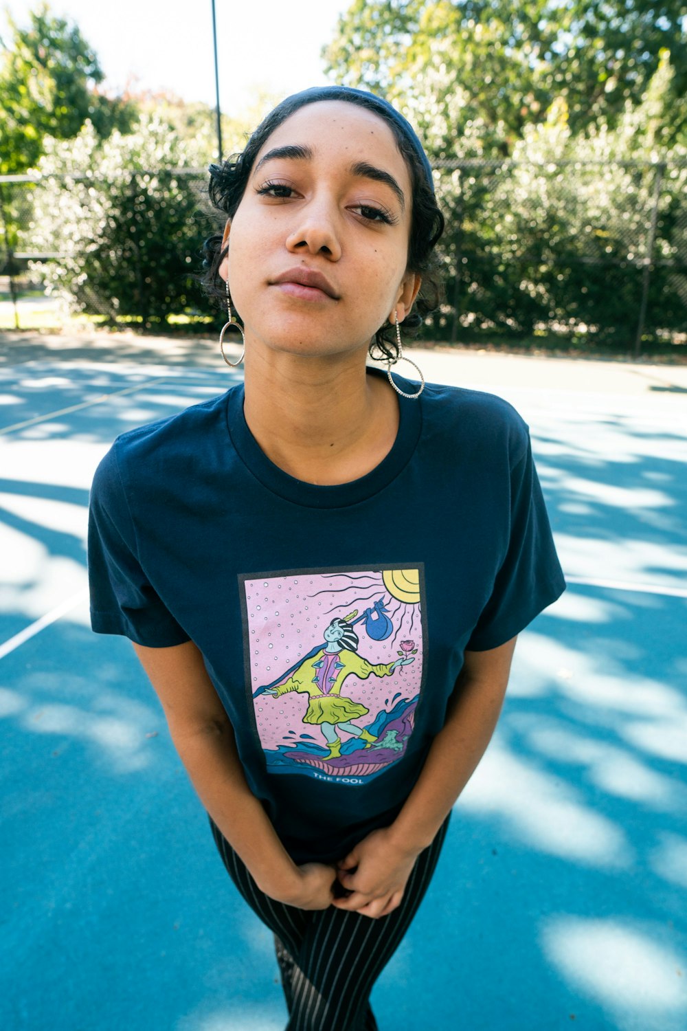 woman in blue crew neck t-shirt wearing white earbuds