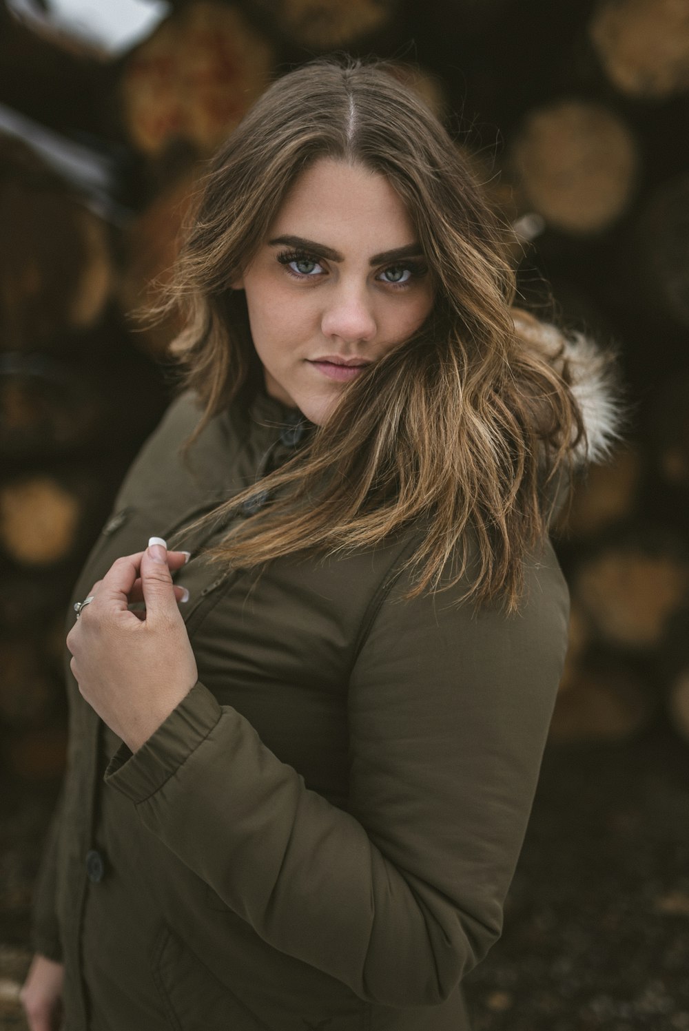 woman in black coat holding her hair