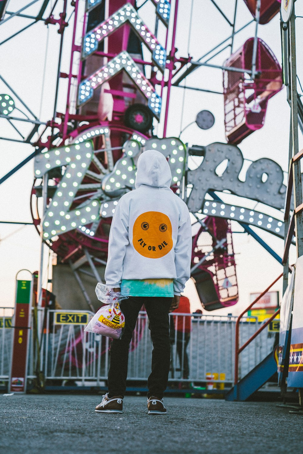 Persona in costume bianco e giallo di Babbo Natale in piedi sulle montagne russe blu e rosse