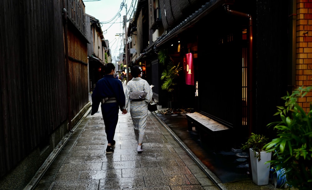 man in black jacket walking on sidewalk during daytime