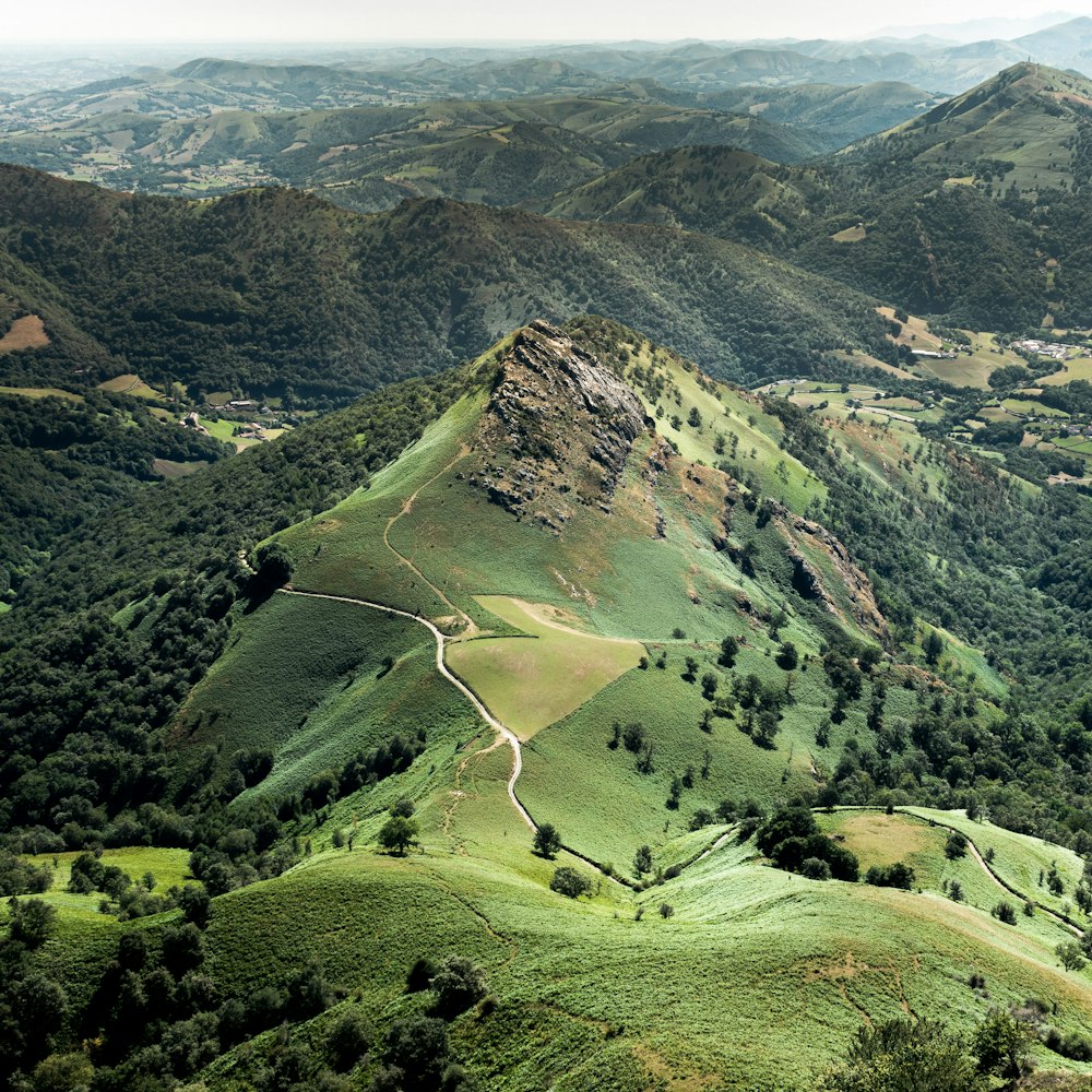 green grass field and mountains during daytime