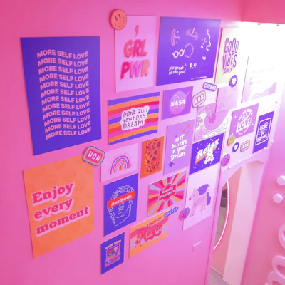 Artistic prints of empowering quotes paired with colorful photography hanging on a cozy wall.