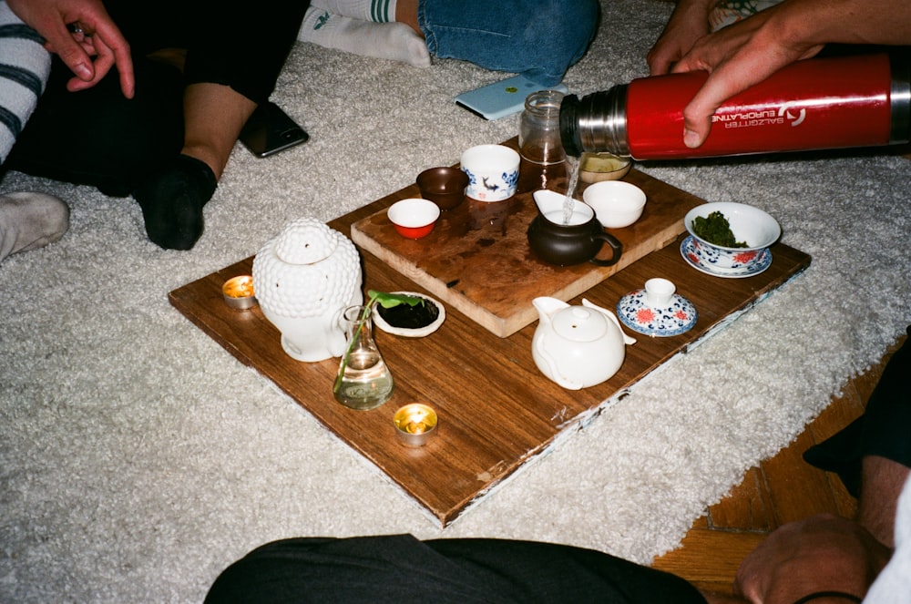 white ceramic teacup on brown wooden tray