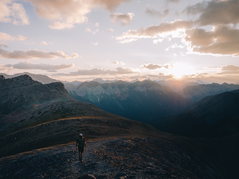 person standing on mountain during daytime