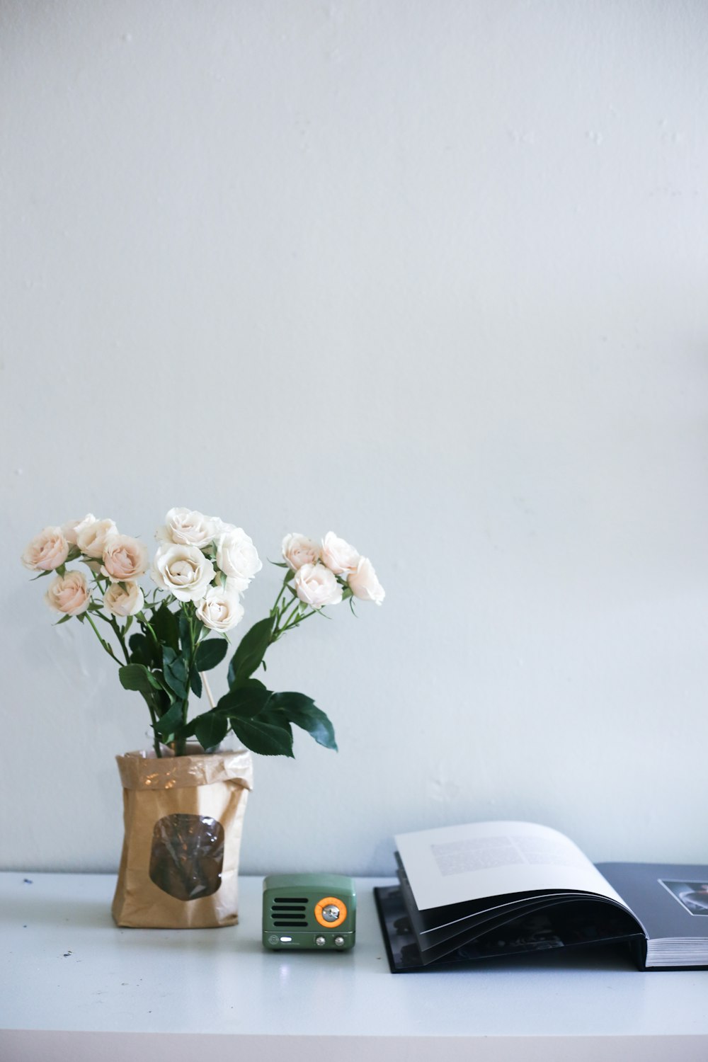 white and pink flowers in brown glass vase