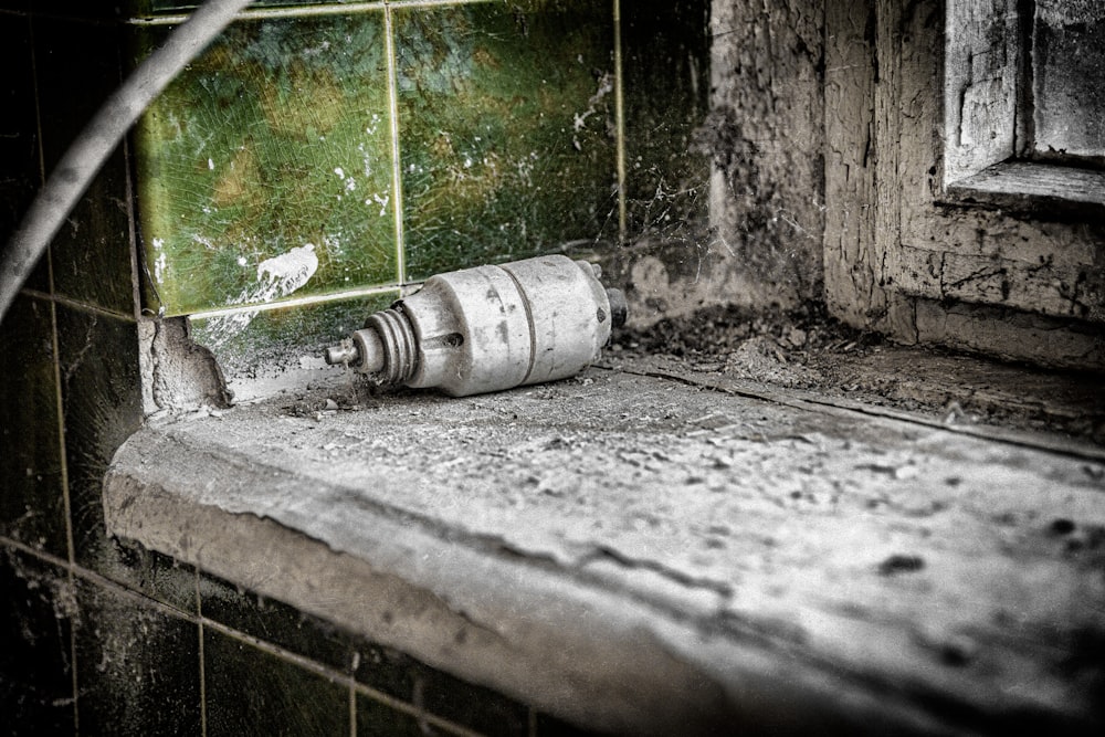 grayscale photo of water pipe on wall