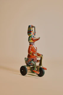 brown and red robot riding on red and black trike