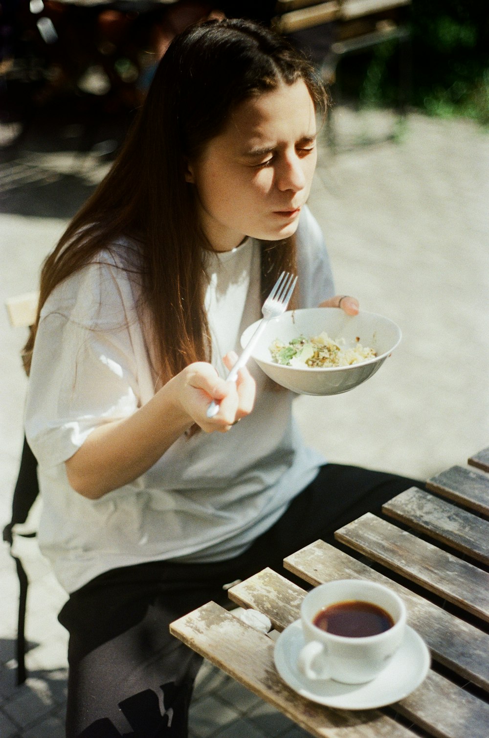 woman in white shirt holding spoon