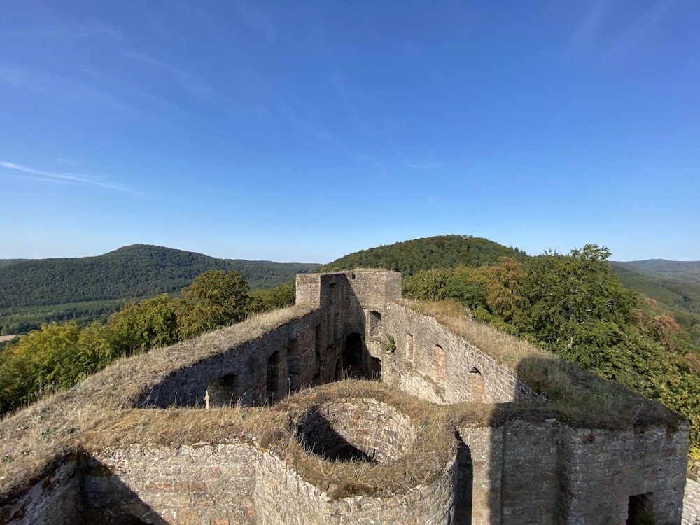 gray concrete building on top of mountain during daytime