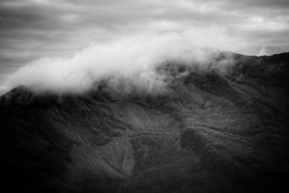 grayscale photo of mountain with clouds