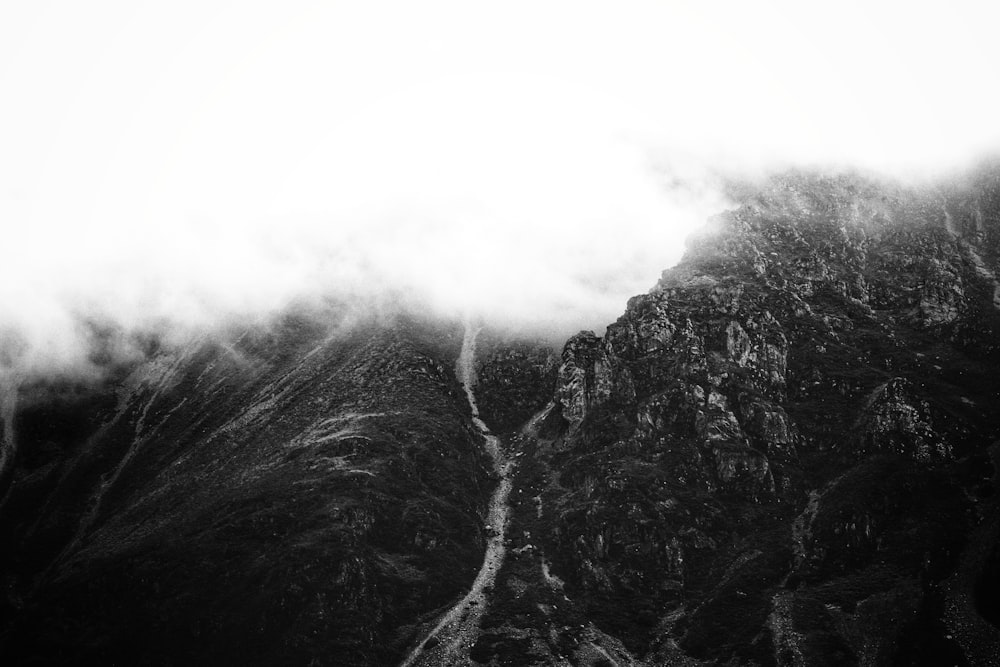 grayscale photo of mountain with fog