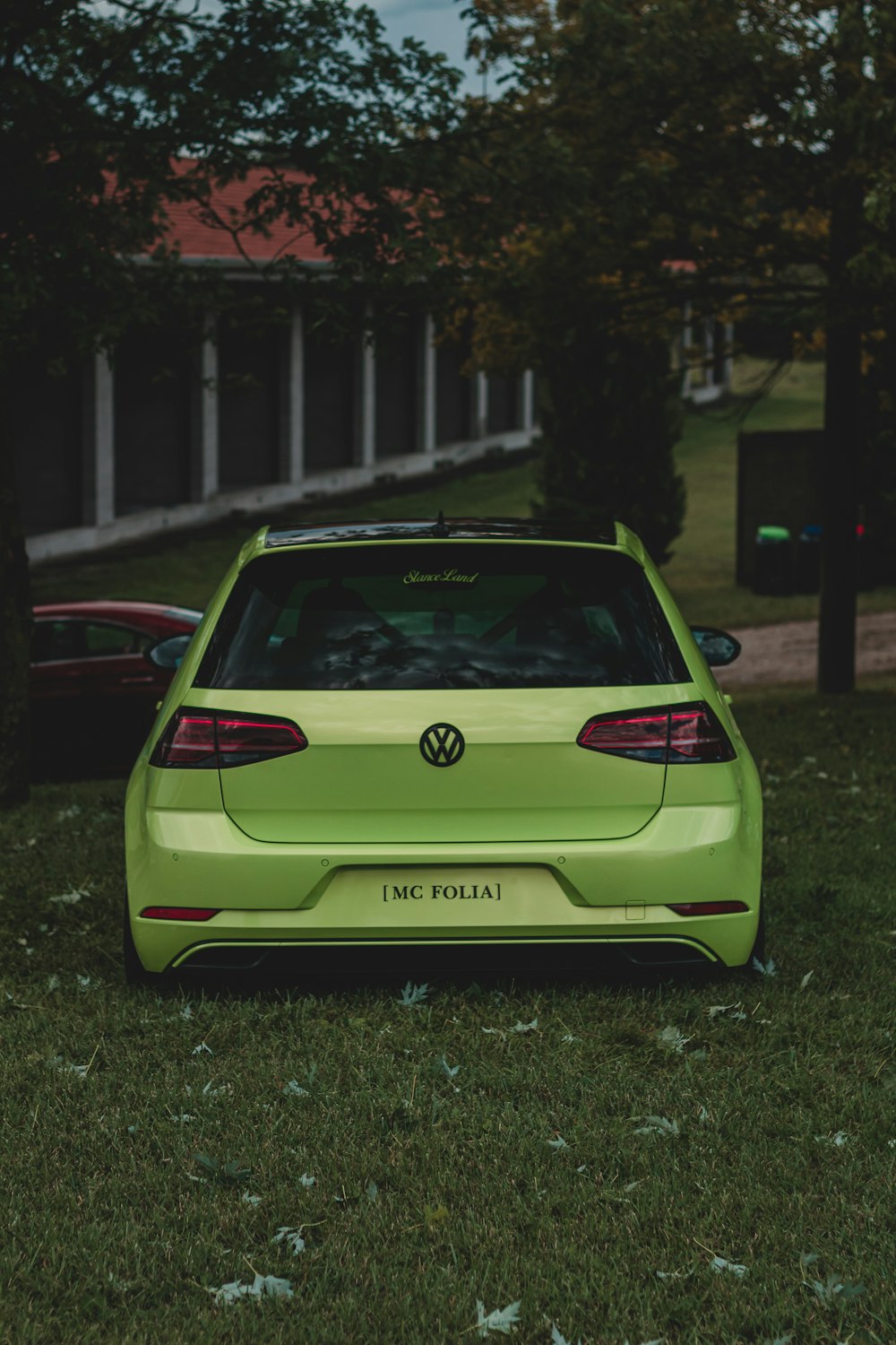 green volkswagen car parked on the side of the road