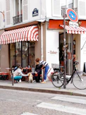 people sitting on bench near building during daytime