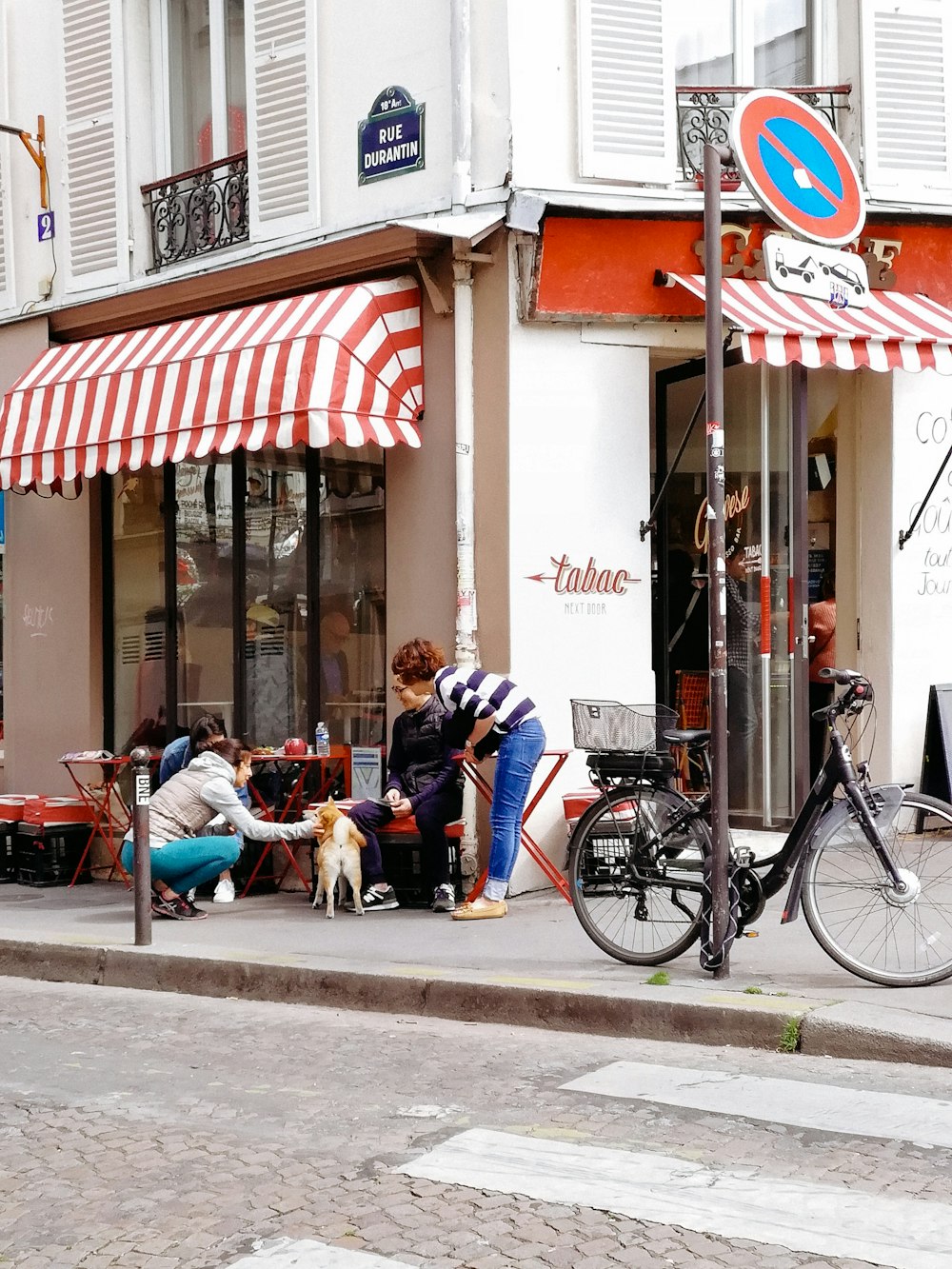 people sitting on bench near building during daytime