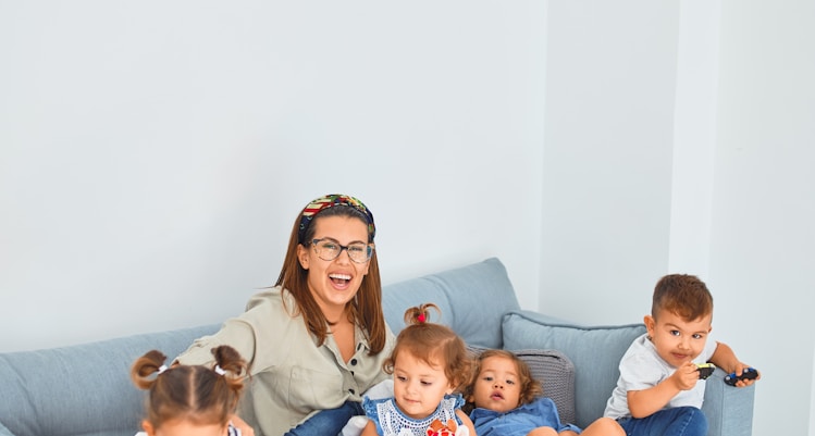 3 women sitting on gray couch