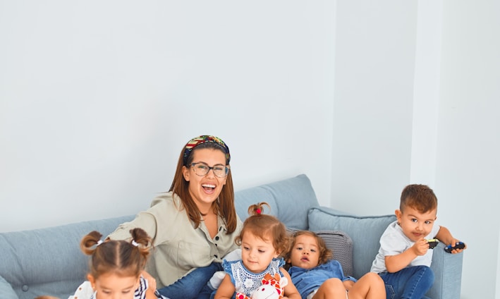 3 women sitting on gray couch