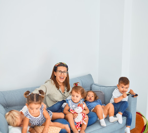 3 women sitting on gray couch