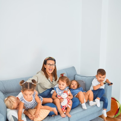 3 women sitting on gray couch