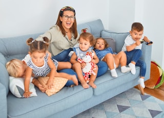 3 women sitting on gray couch