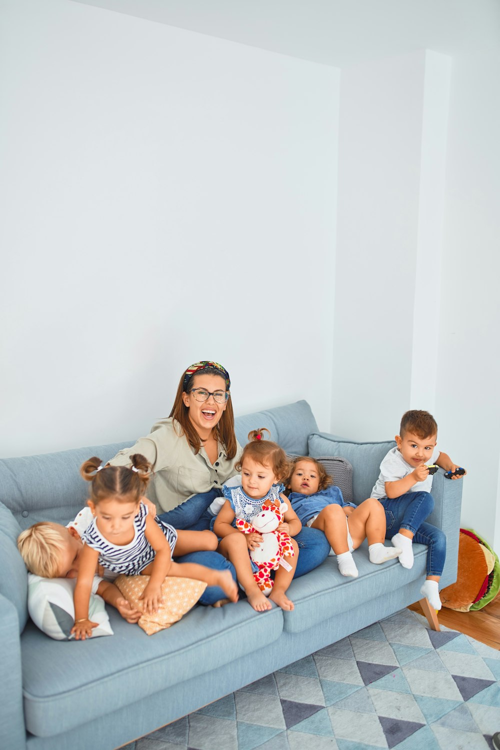 3 women sitting on gray couch