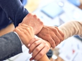 person in black long sleeve shirt holding persons hand