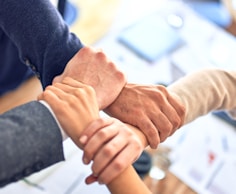 person in black long sleeve shirt holding persons hand