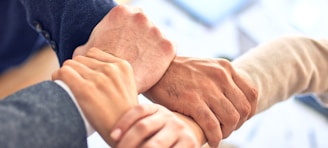 person in black long sleeve shirt holding persons hand