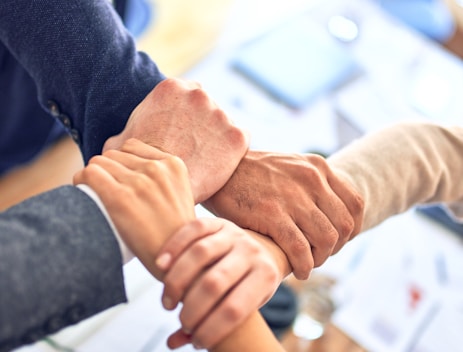 person in black long sleeve shirt holding persons hand