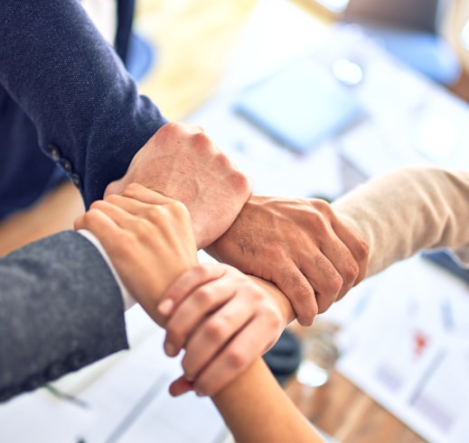 person in black long sleeve shirt holding persons hand