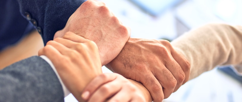 person in black long sleeve shirt holding persons hand